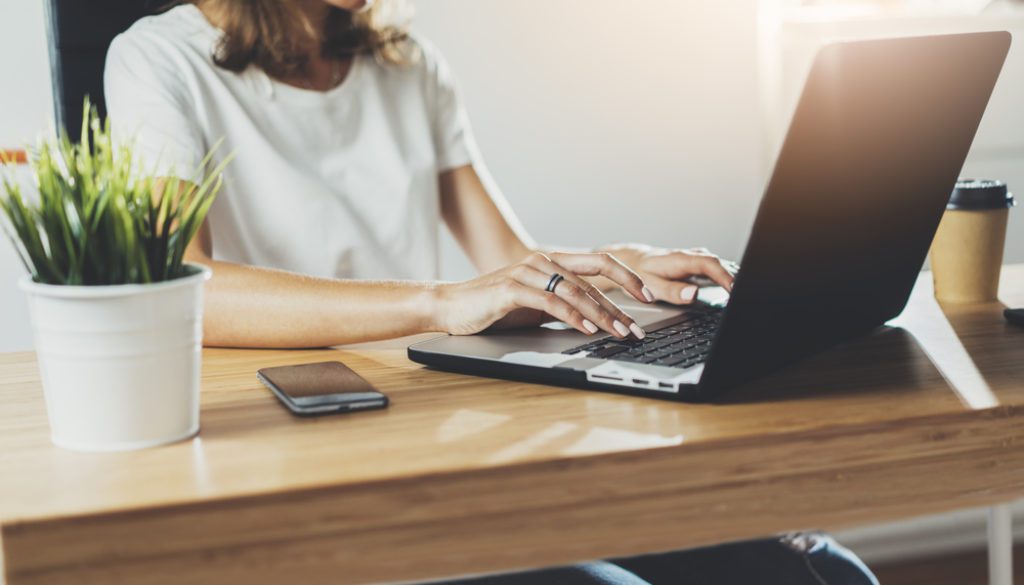 woman typing on laptop computer