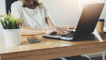 woman typing on laptop computer