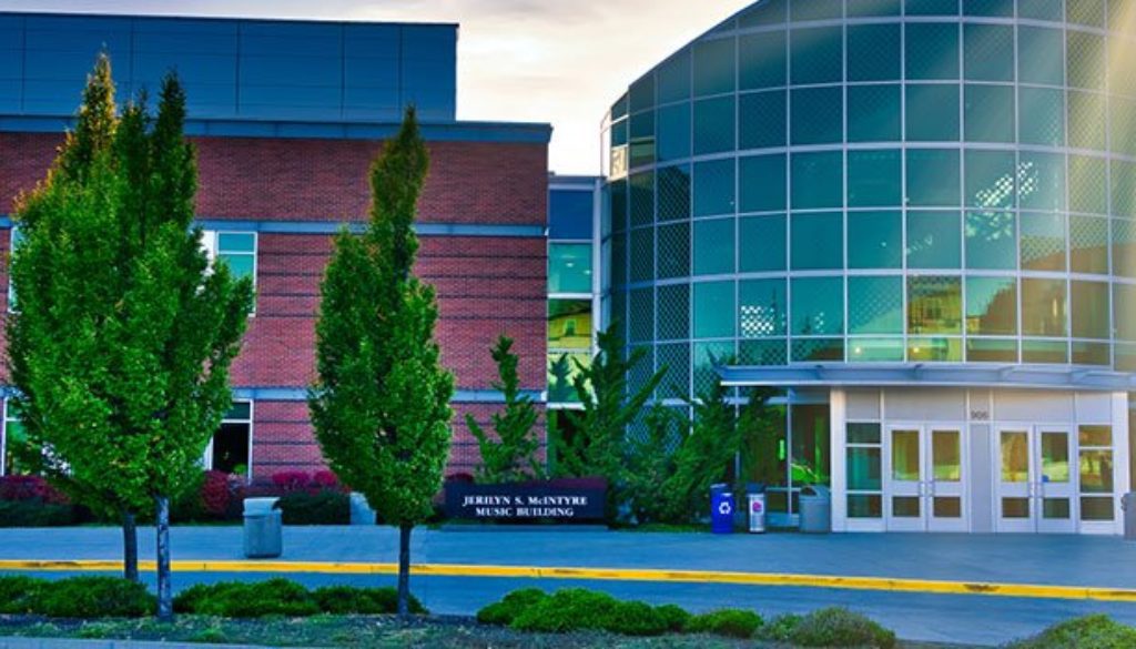 central washington university campus building with sun reflecting off the glass