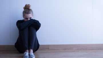 student sitting alone in the corner