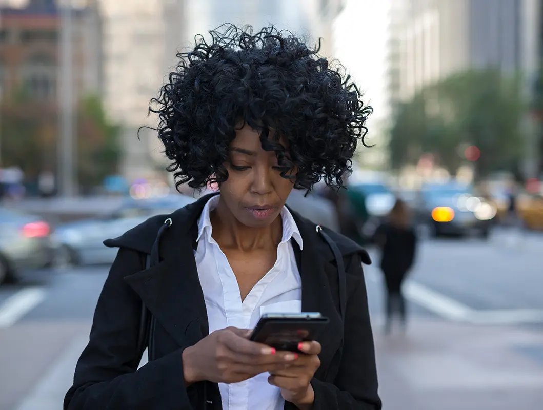business-woman-on-phone-in-city-stock-image Business woman in New York City texting on cell phone