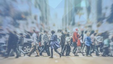 crowd walking on crosswalk at busy intersection in city