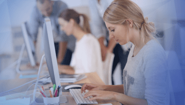 girl working at desktop computer