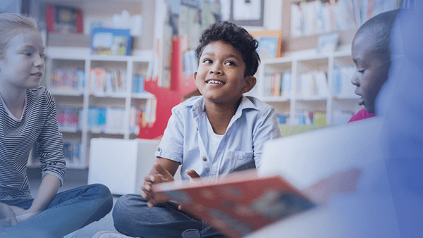 kids sitting in circle reading together at school