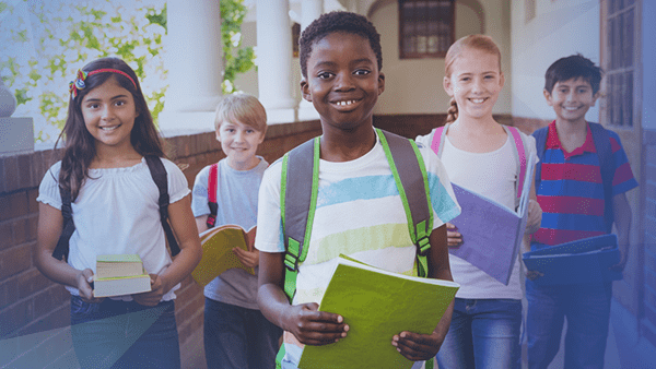 kids smiling walking down hallway together