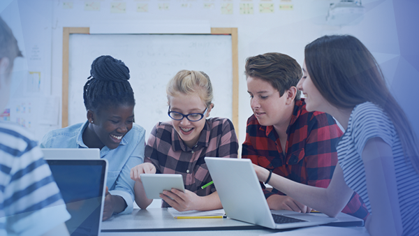 middle school students working together computers