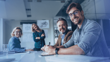 office employees smiling siting together