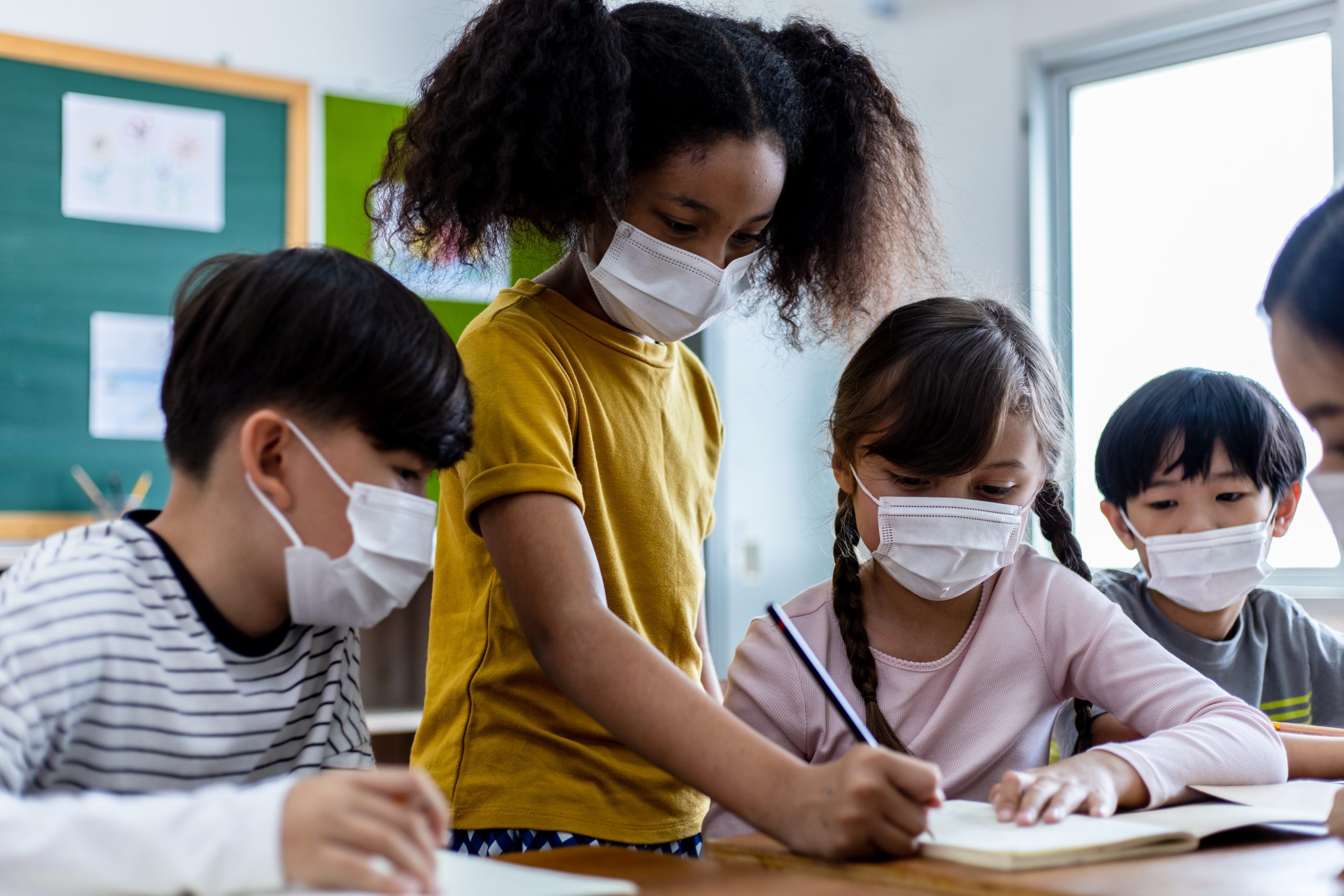 students with masks A Group Of Children Students Wearing Medical Masks In Classroom