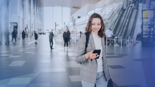 woman walking looking at cellphone 