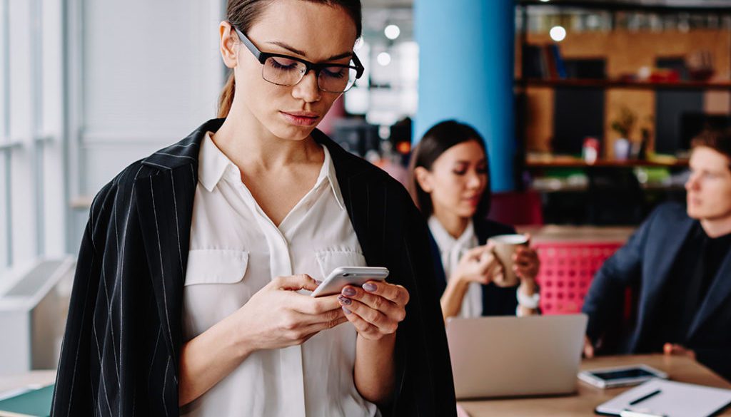 Serious Caucasian Businesswoman In Formal Wear Checking Notification On Mobile