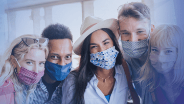 group of people wearing masks standing together