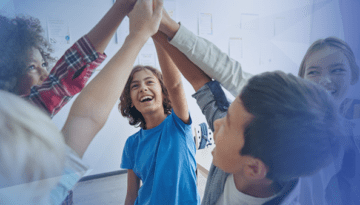 kids in school give group high five