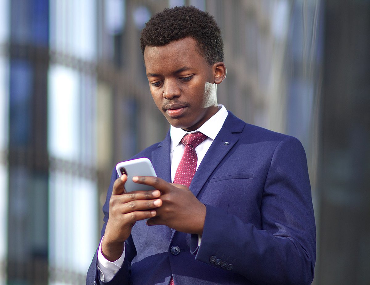 Serious,Businessman,Looking,At,His,Cell,Mobile,Phone,,Typing,A