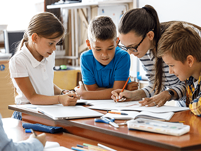 teacher and students working together in classroom