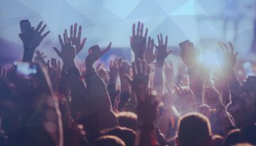 crowd of people with hands in the air at an event