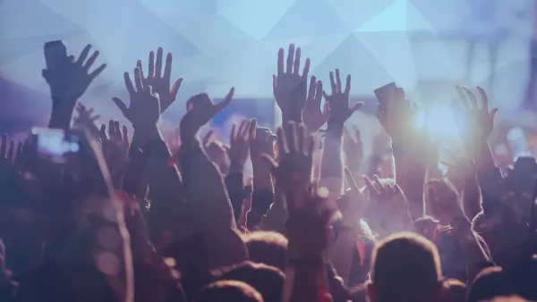 crowd of people with hands in the air at an event