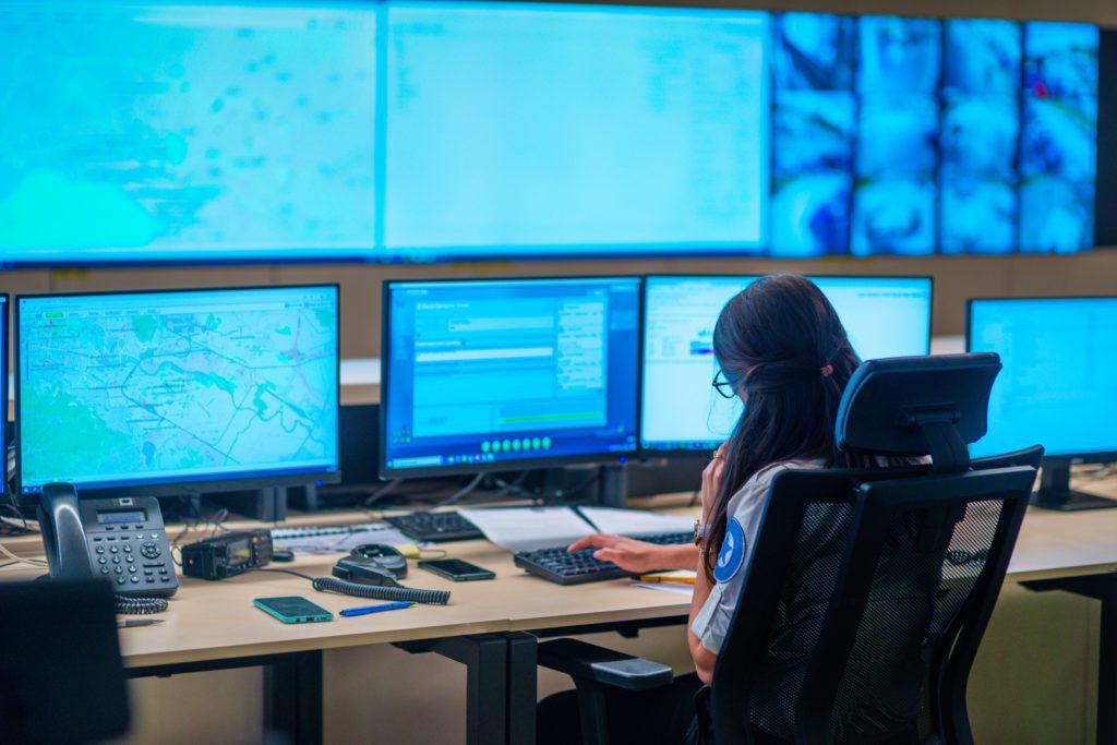 emergency dispatcher sitting in front of computer screens
