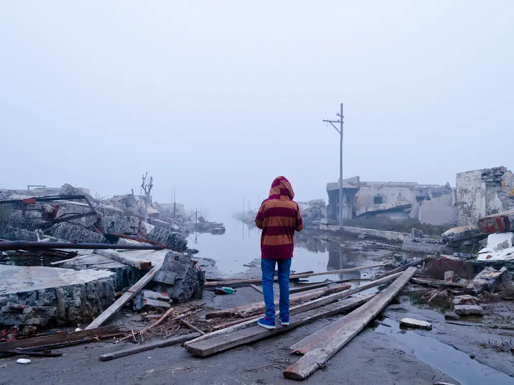 Person looking at the aftermath of a severe weather event