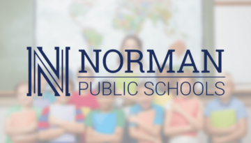 Norman Public Schools logo in front of students and teacher in classroom