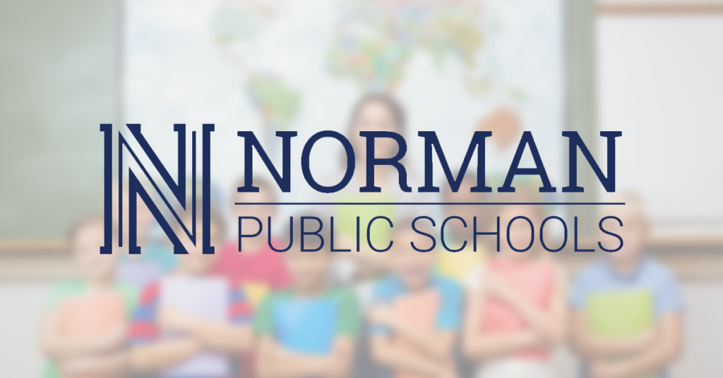 Norman Public Schools logo in front of students and teacher in classroom