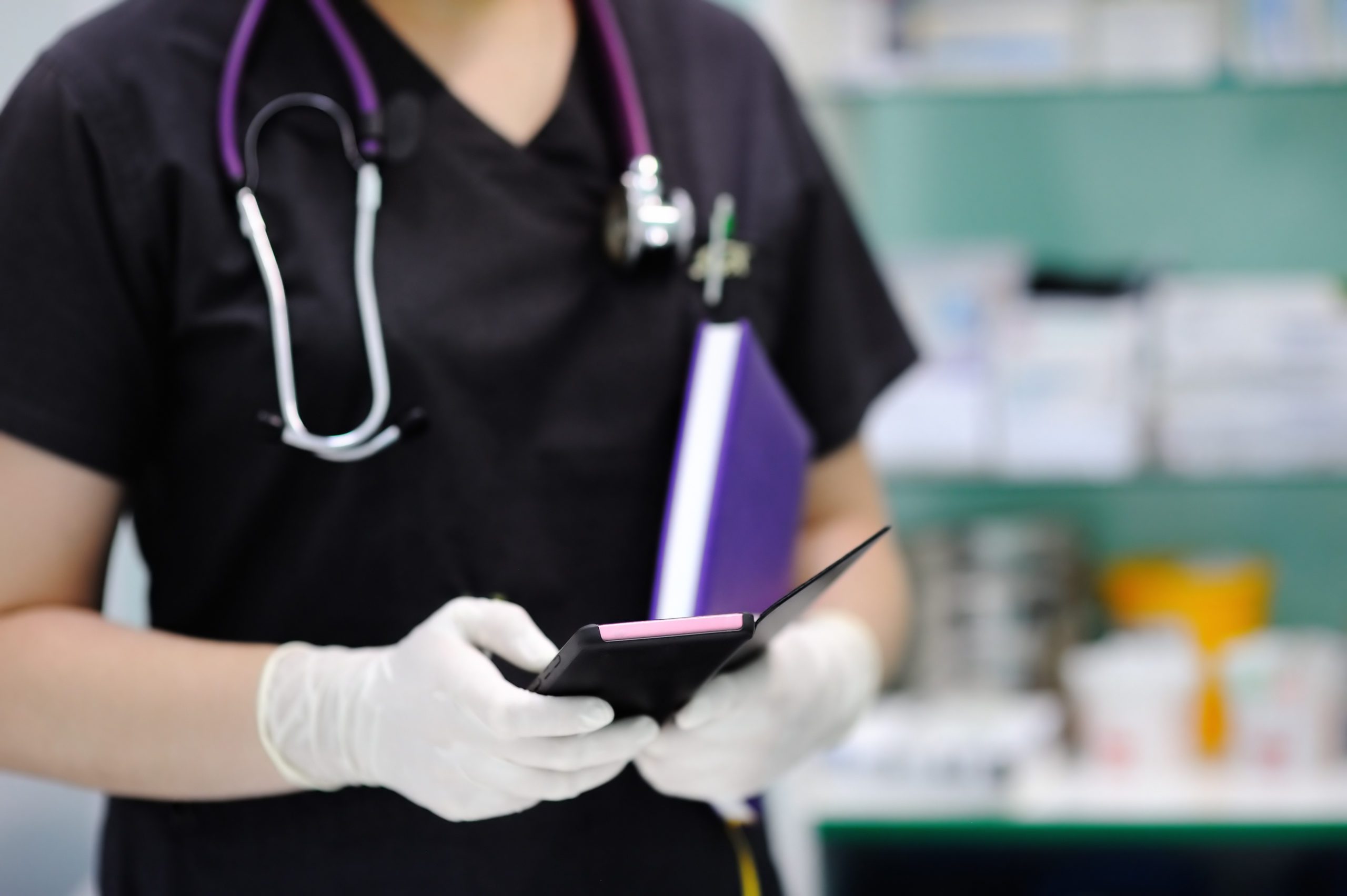 nurse-phone nurse using cell phone wearing scrubs