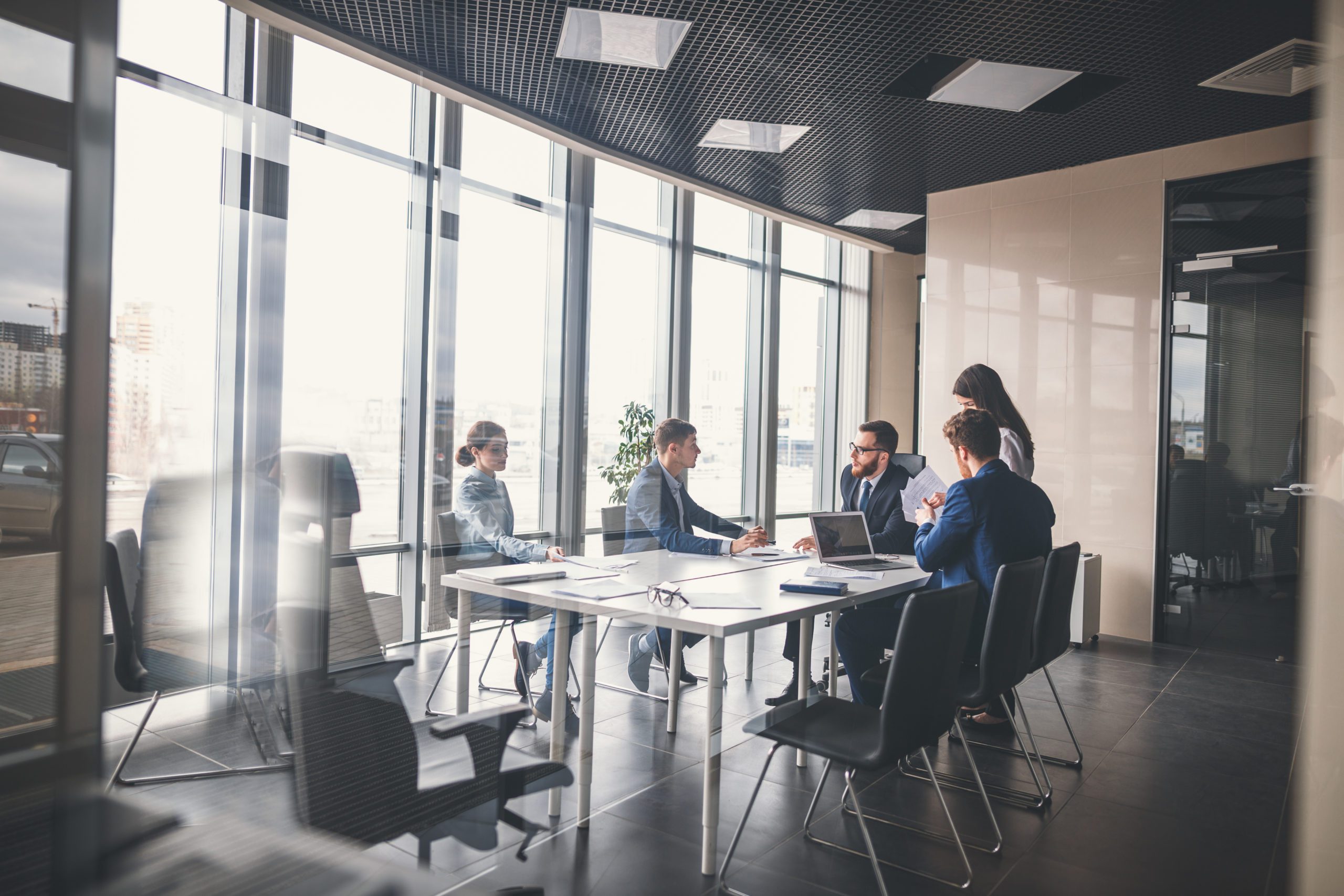 employees working in an office around a desk