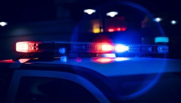 Closeup of police lights on dark street at night