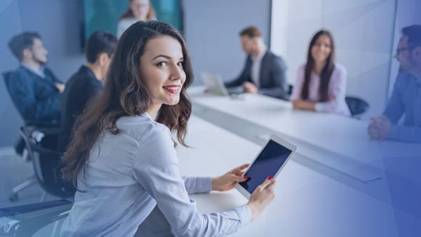 corporate employee woman working on tablet in meeting