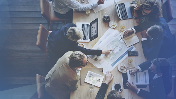 corporate employees meeting at large table