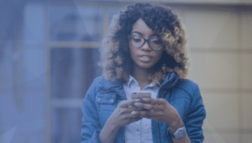 woman holding a cell phone looking at the screen