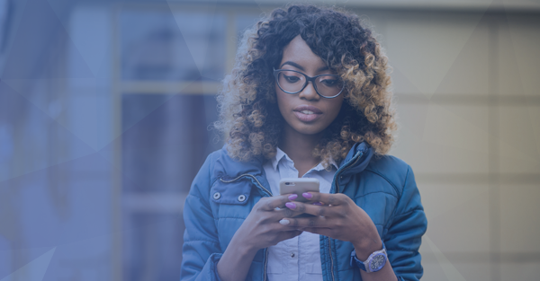 woman holding a cell phone looking at the screen