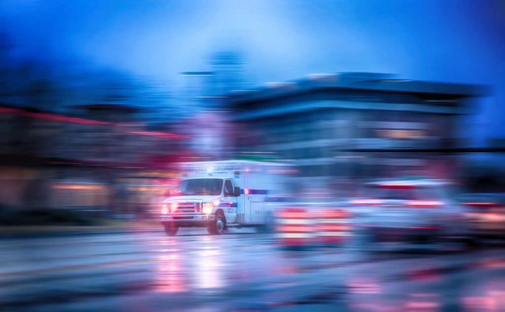 ambulance driving with lights on