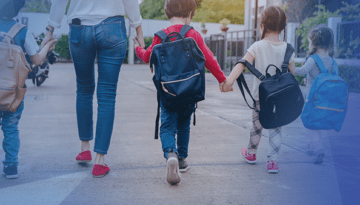 kids holding hands together with teacher walking