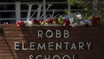 flowers on top of the Robb Elementary School sign