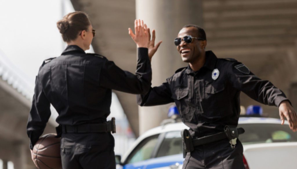 Police Officers With Basketball Ball Giving High Five