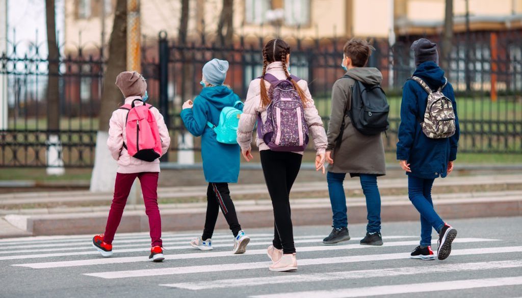 young students walking on a crosswalk