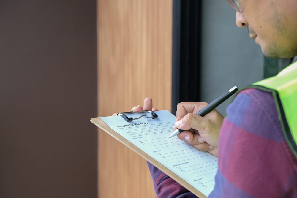 checklist on a clipboard held by warehouse worker