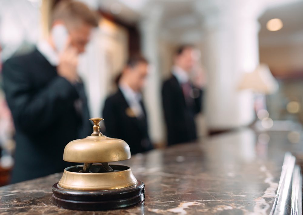 concierge hotel check in desk with bell on counter