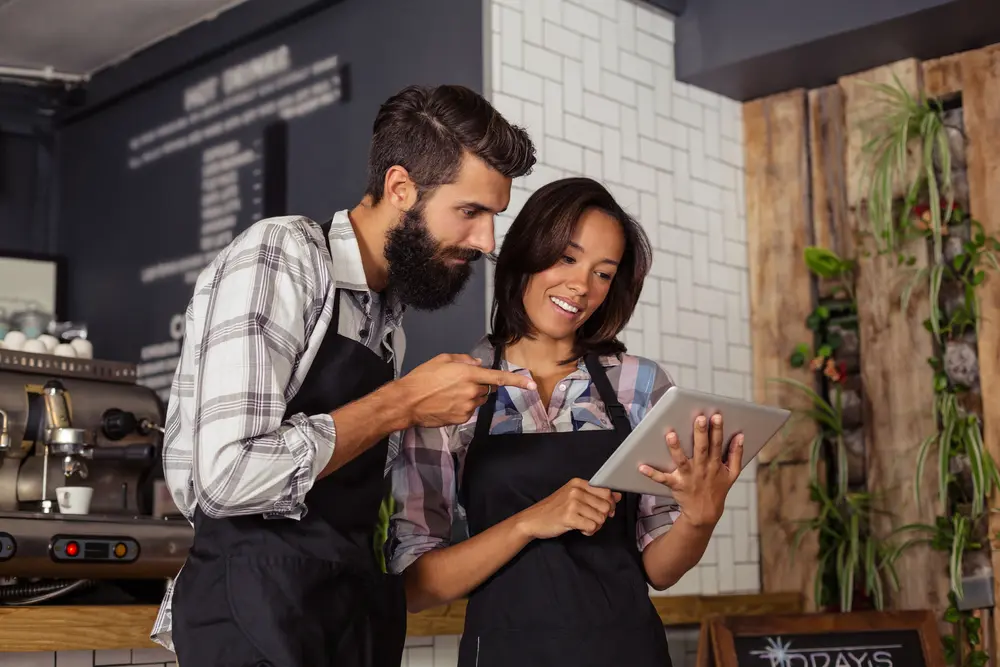 restaurant-workers-looking-tablet