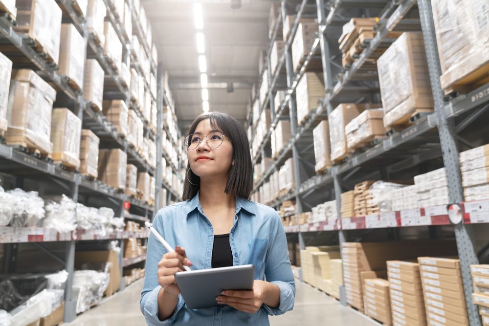 warehouse-worker-taking-inventory warehouse worker using tablet taking inventory