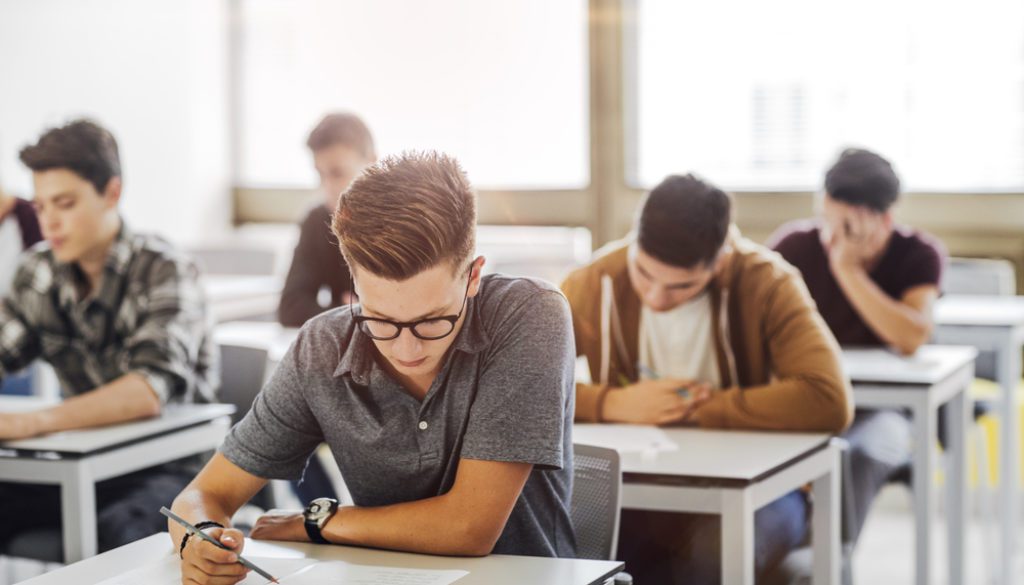 high school students sitting at desks in classroom