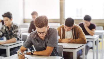 high school students sitting at desks in classroom