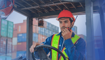 man-driving-forklift-using-walkie-talkie