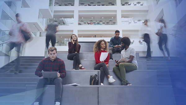 college students sitting on campus working and studying