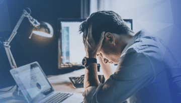 corporate office man frustrated holding head