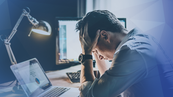 corporate office man frustrated holding head