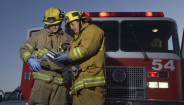 fire fighters standing in front of fire truck