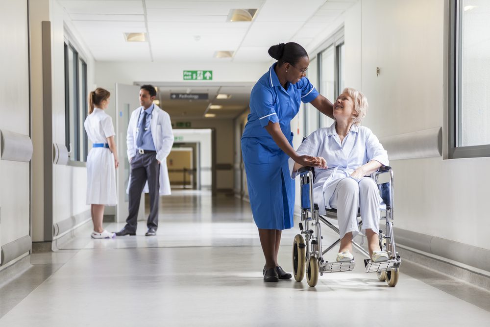 nurse pushing patient in a wheel chair