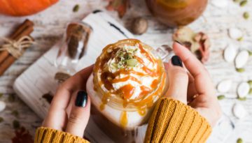 girl's hands holding pumpkin spice latte