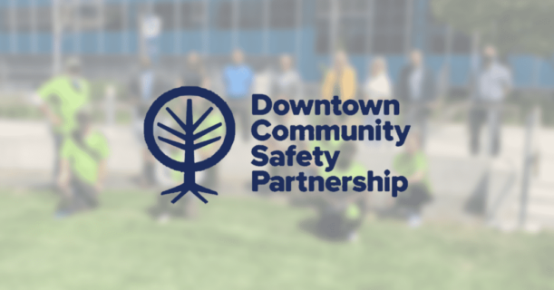 downtown community partnership logo over group of people in background
